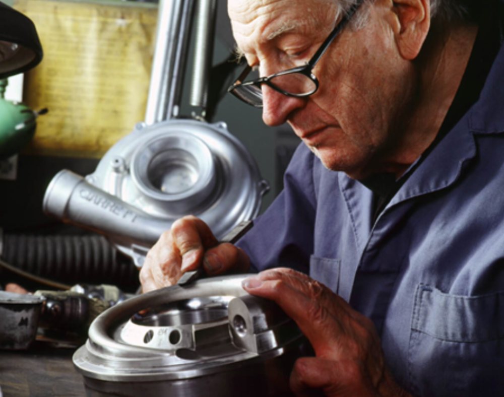 Elba craftsman inspecting a precision-machined part