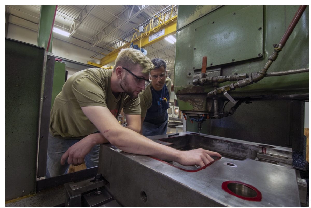 Elba toolmakers collaborating at an EDM machine